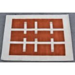 Modern machine woven rug of Art Deco design in shades of rust, cream and beige, 240cms x 170cms