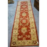 Modern Afghan Ziegler design runner with a palmette and floral pattern on a rust ground with ivory