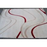 Modern machine woven rug of Art Deco design in shades of beige and red, 232cms x 160cms, together