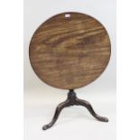 Good 18th Century mahogany circular pedestal table, the figured tilt top above a vase turned
