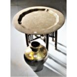 Benares brass circular tray top occasional table on a folding wooden stand, together with a brass