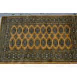 Pakistan rug of Turkoman design with two rows of gols on a beige ground with borders, 153cms x 94cms