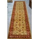 Indo Persian runner with stylised floral design on an ivory ground with red ground borders, 290cms x