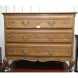 French oak straight front chest of three carved moulded drawers, raised on cabriole supports,
