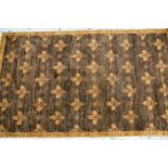 Small Afghan rug with an all-over fleur de lis design in shades of tan, 174cms x 106cms