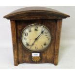 Arts and Crafts oak two train mantel clock with a circular dial and Arabic numerals, 28cms high