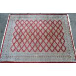 Pakistan carpet of Turkoman design, with an all-over geometric pattern on a red ground with