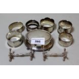 Oval Birmingham silver trinket box, six various silver napkin rings and a pair of silver knife rests