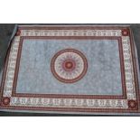 Modern machine woven rug with a circular medallion on a grey ground with borders, 286cms x 198cms