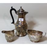 Three piece London silver teaset with embossed wrythen decoration and ebonised handle, 22oz t,