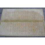 Modern Tibetan carpet with a two panel Key pattern design in shades of beige and pale green (some