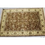 Small Indo Persian rug with an all-over stylised floral design in shades of beige and cream,