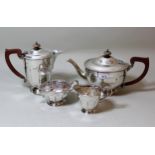 Birmingham silver four piece tea service of circular faceted design with Bakelite handles, overall