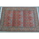 Sparta carpet with all-over stylised floral and vase design on a pink ground 296cms long x 202cms