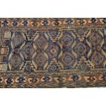 Belouch rug with an all-over hooked medallion design on a midnight blue ground with borders, (slight