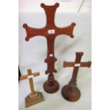 Group of three carved oak church crosses, 30cms to 67cms