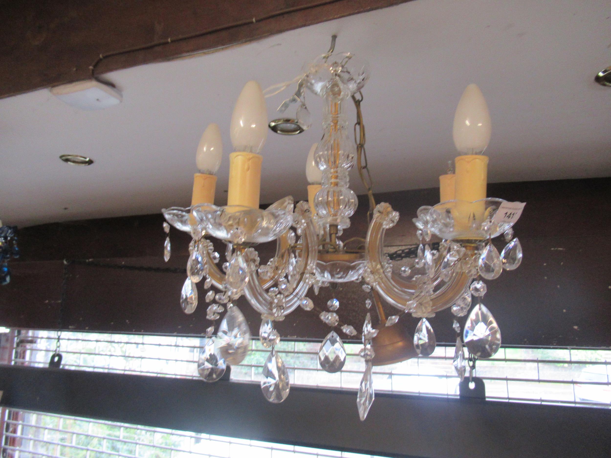 Two modern Venetian style chandeliers, one with clear glass arms, the other with blue glass arms