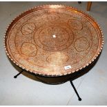 Circular Benares copper table on wrought iron base, 68cms diameter Base is 50cm tall