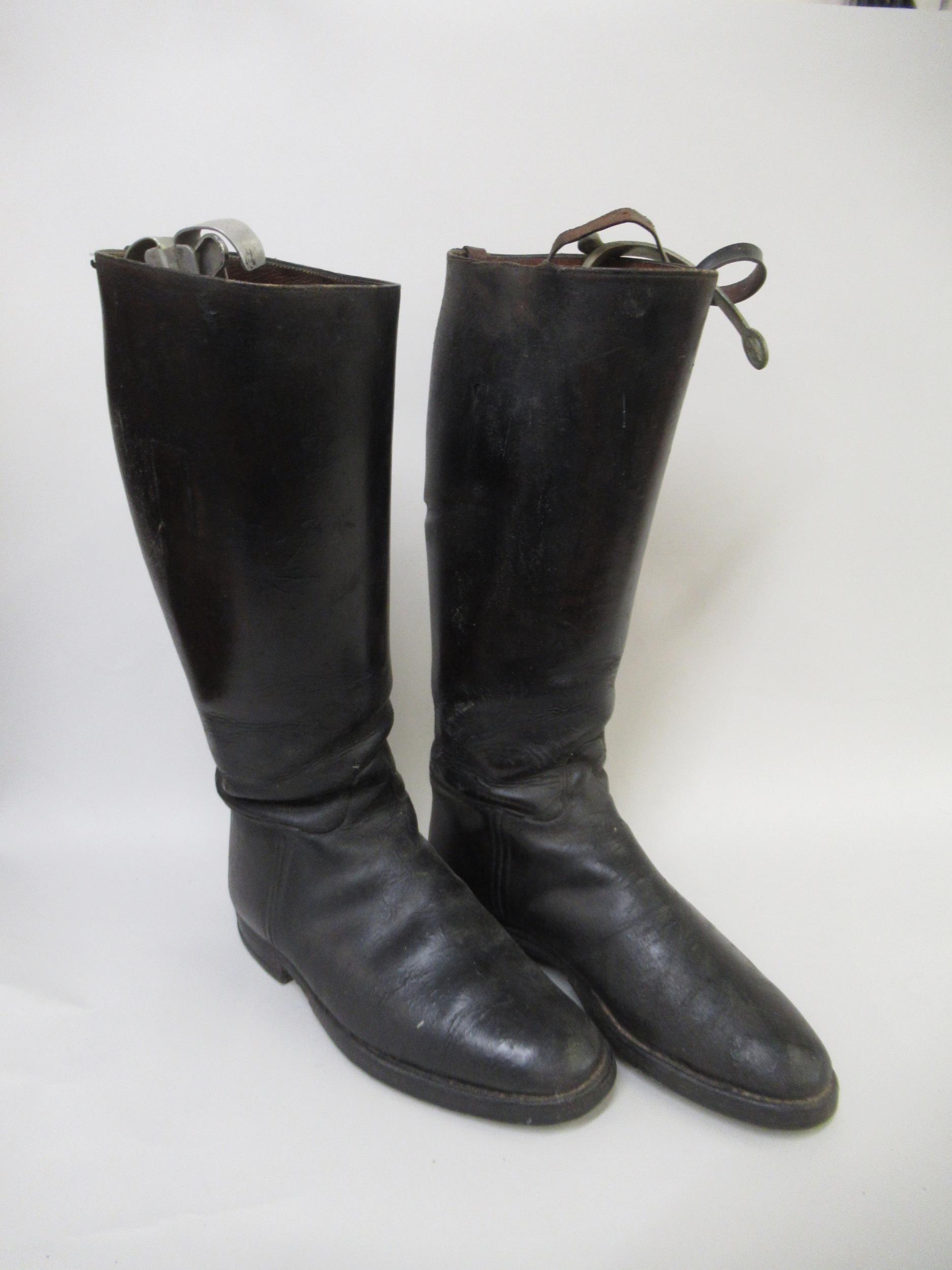 Pair of black leather riding boots with spurs