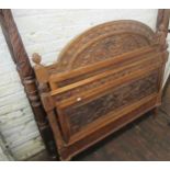 19th Century Continental carved walnut bedstead, the headboard decorated with patera and floral