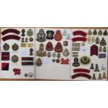 Three cards mounted with various cloth and metal military badges including Royal Artillery, Royal