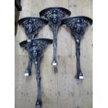 Two pairs of powder coated cast iron pub table legs with mask head decoration