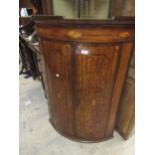 George III mahogany and line inlaid two door bow front hanging corner cabinet, 106cms high Loss of