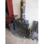Large late 20th Century log burner with panelled front, and brass knob handles, 76cms high x 89cms
