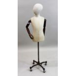 20th Century antique style dressmaker's dummy with articulated wooden arms on metal stand This is