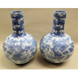 Pair of late 19th Century Japanese blue and white bottle vases, decorated with pheasants in foliage,