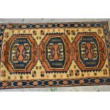 Small Turkish rug of Caucasian design with a triple medallion in shades of blue, rose and ivory,