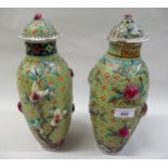 Pair of late 19th / early 20th Century Chinese oviform vases, with covers, the relief decoration