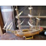 Wooden model of a three masted ship on wooden stand, 72 x 87cms wide