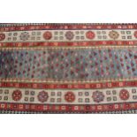 Antique Kazak runner, with all-over stylised floral design on blue ground, with rosette borders,