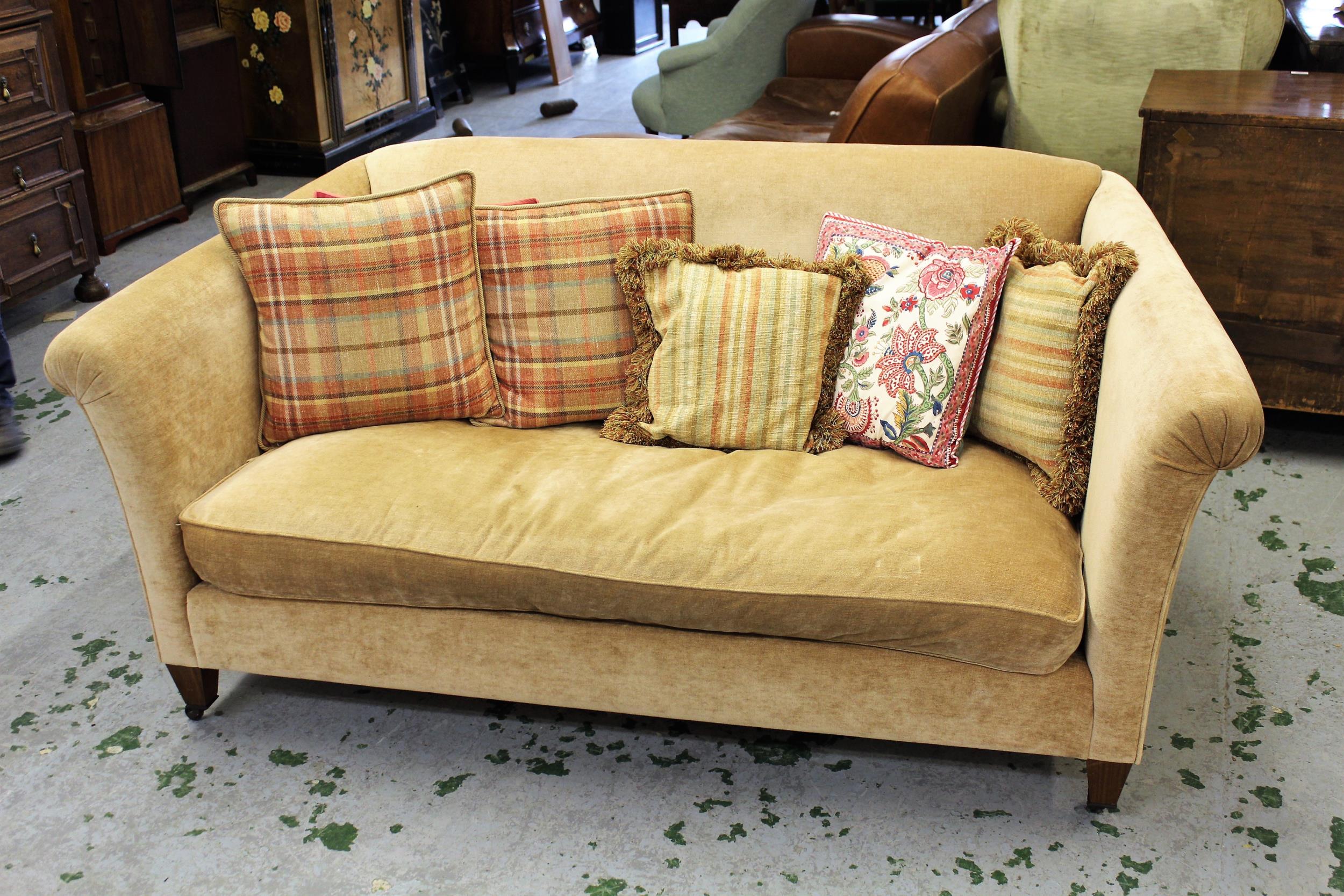 Kingcombe Chelsea two seater sofa, covered in Colefax and Fowler biscuit fabric, raised on low