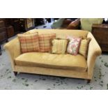 Kingcombe Chelsea two seater sofa, covered in Colefax and Fowler biscuit fabric, raised on low