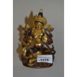 Small 20th Century Indian dark gilt and painted bronze figure of seated Buddha, 13cms high