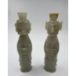 Pair of 20th Century pale carved jade figures of immortals, 14cm high approximately