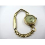 Ladies circular 9ct gold cased wristwatch on a gold plated bracelet strap