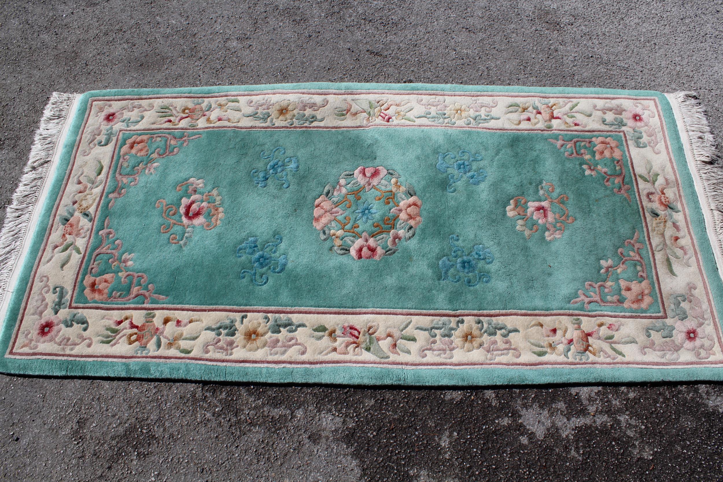 Modern rectangular Chinese rug with all-over floral design and borders on a green ground, 93cms x - Image 2 of 2