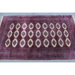 Pakistan rug of Turkoman design with three rows of nine gols, 208cms x 125cms