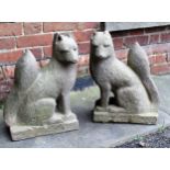 Pair of composite stone garden figures of seated foxes, 49cms high