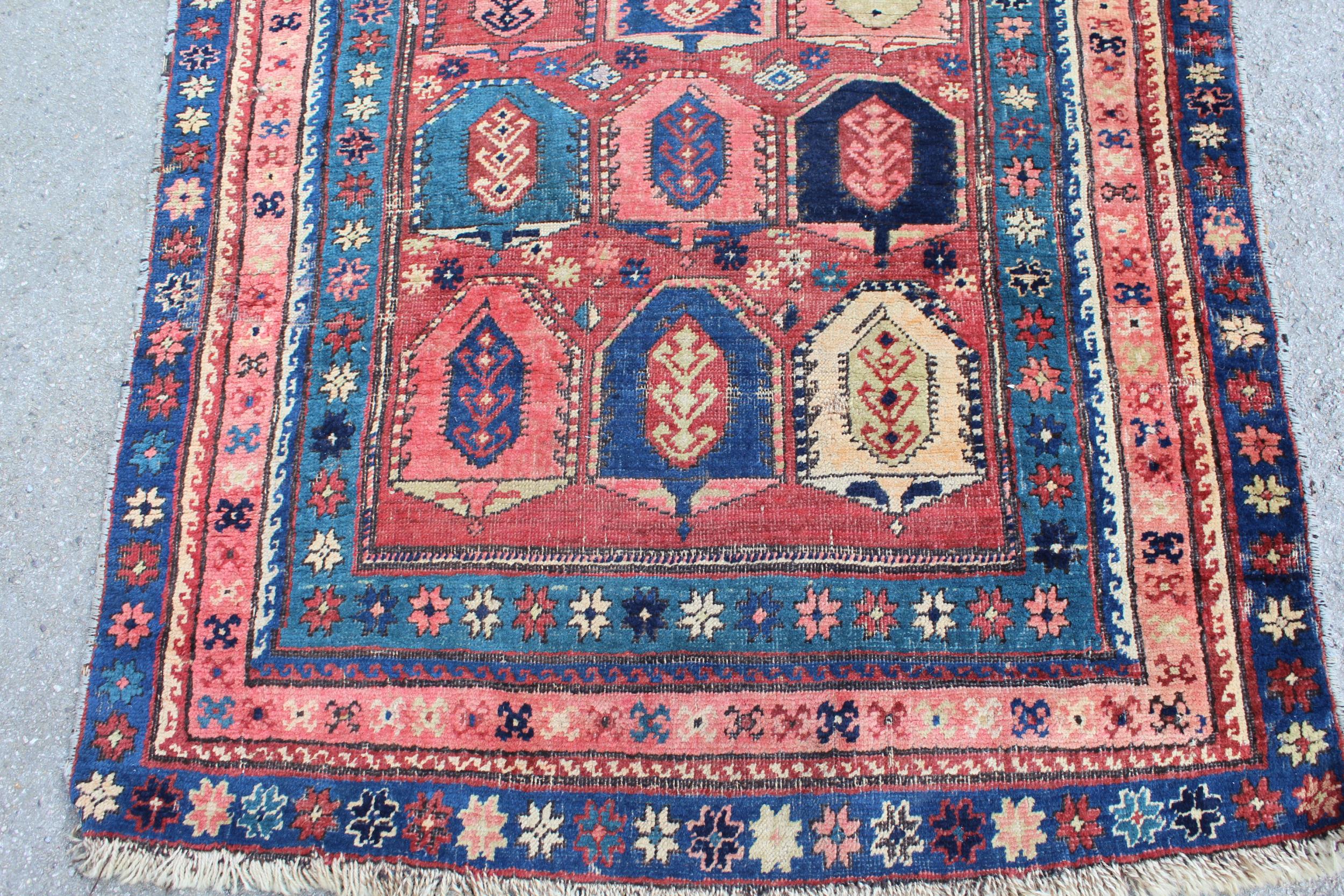 Kazak runner with an all-over stylised design on a brick red ground with borders, 250cms x 108cms - Image 3 of 5