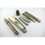 Two 9ct gold cased propelling pencils, three various pocket knives, silver thimble and another