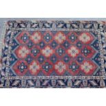 Turkish carpet with an all-over medallion design in shades of blue, rose and cream, 290cms x 201cms