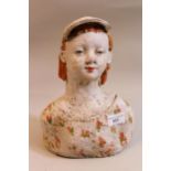 20th Century Continental stoneware bust of a child wearing cap, 27cms high