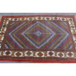 20th Century Turkish rug of Caucasian design with a polychrome geometric centre panel and borders,