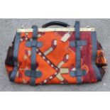 Modern Kelim carpet bag with leather and brass fittings, 50cms wide, together with a small Kelim mat