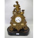 19th Century French gilded spelter mantel clock with a figure surmount, the enamel dial with Roman