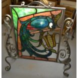 Wrought iron firescreen with coloured , leaded glass panel decorated with a parrot (glass
